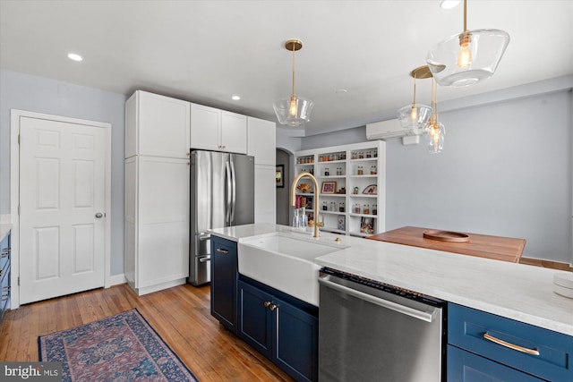 4935 New Hampshire Ave NW, Washington, DC 20011 - kitchen featuring blue cabinetry, white cabinetry, a sink, stainless steel appliances, and light wood finished floors