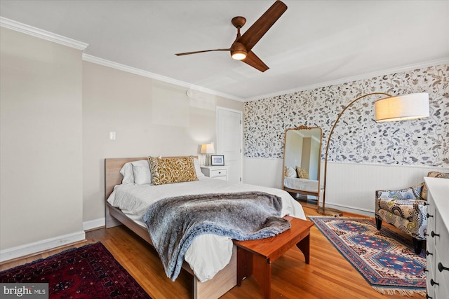 4935 New Hampshire Ave NW, Washington, DC 20011 - bedroom featuring wallpapered walls, a ceiling fan, crown molding, a wainscoted wall, and wood finished floors