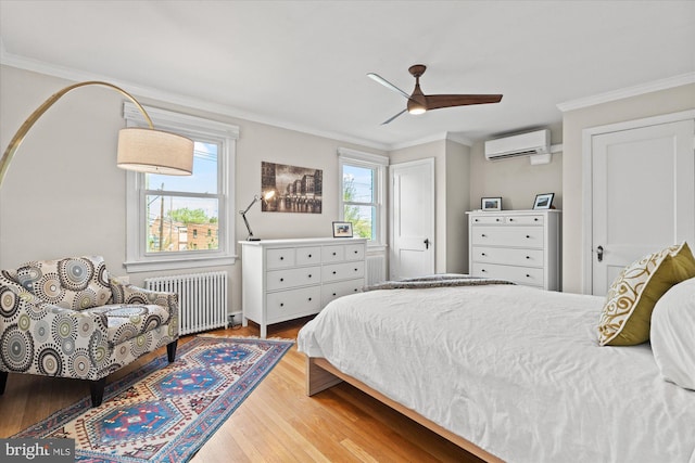 4935 New Hampshire Ave NW, Washington, DC 20011 - bedroom with a wall mounted air conditioner, ornamental molding, radiator, and wood finished floors