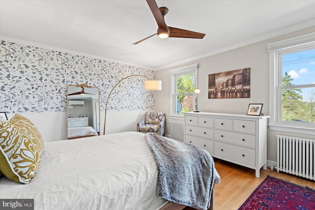 4935 New Hampshire Ave NW, Washington, DC 20011 - bedroom with an AC wall unit, wallpapered walls, crown molding, wainscoting, and radiator