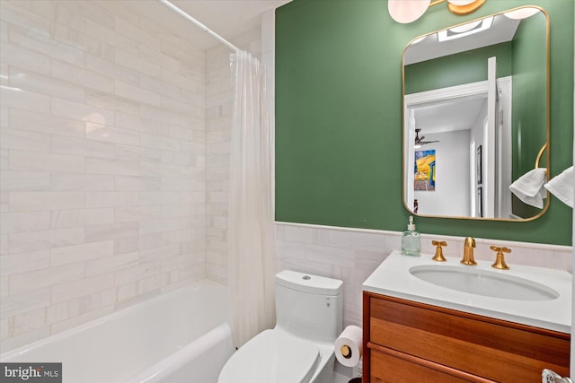 4935 New Hampshire Ave NW, Washington, DC 20011 - bathroom featuring vanity, toilet, wainscoting, tile walls, and shower / tub combo