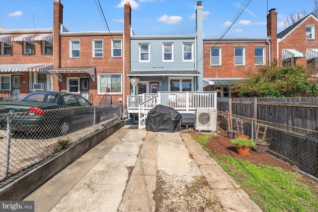 4935 New Hampshire Ave NW, Washington, DC 20011 - rear view of house with brick siding, fence, and ac unit