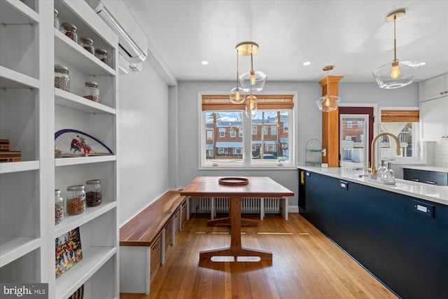 4935 New Hampshire Ave NW, Washington, DC 20011 - dining area featuring radiator heating unit, light wood finished floors, recessed lighting, and a wall mounted air conditioner