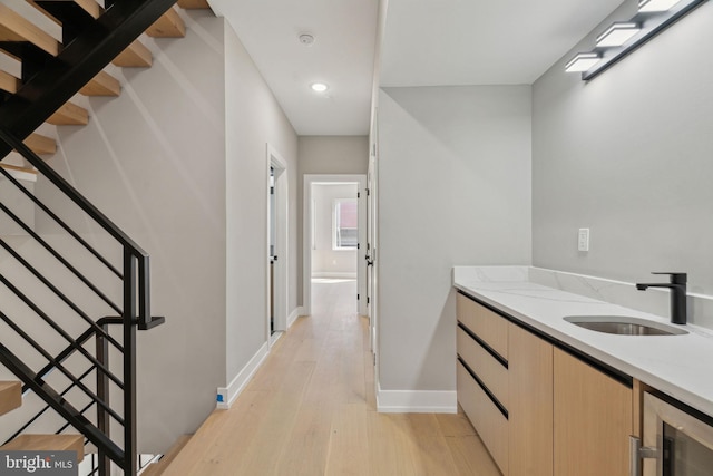 bathroom featuring baseboards, wine cooler, recessed lighting, vanity, and wood finished floors