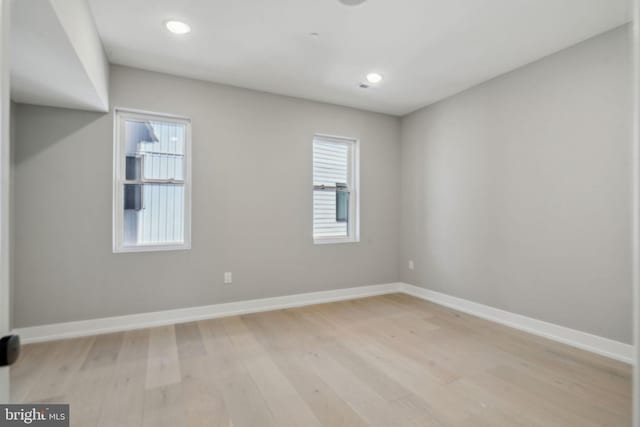 unfurnished room featuring recessed lighting, light wood-style flooring, and baseboards