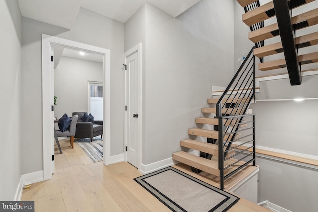 stairs with wood-type flooring and baseboards