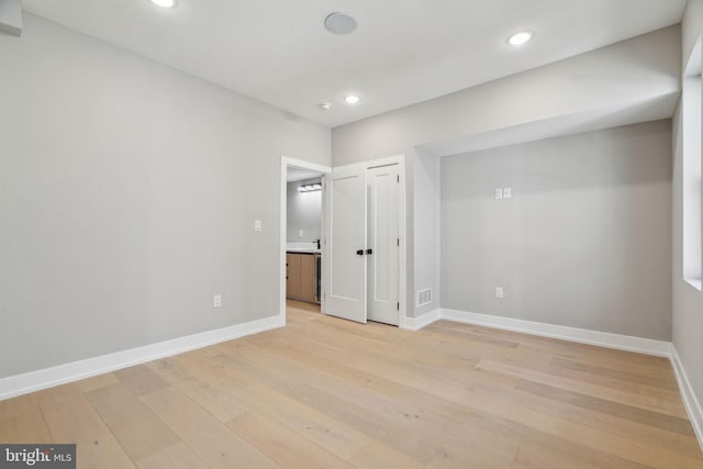 unfurnished bedroom with baseboards, recessed lighting, and light wood-style floors