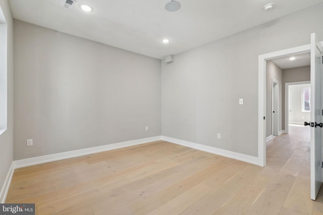 spare room featuring recessed lighting, light wood-style flooring, baseboards, and visible vents