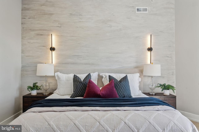 bedroom featuring baseboards and visible vents