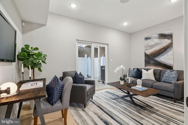 living area with recessed lighting and light wood-style floors