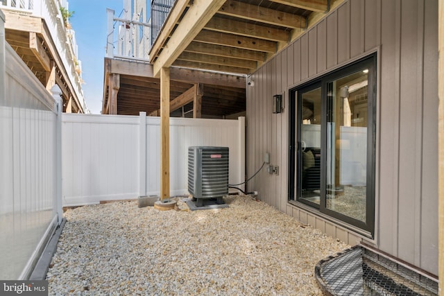 view of patio featuring central AC unit and fence