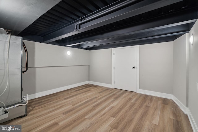 finished below grade area featuring light wood-style flooring and baseboards