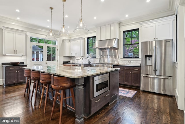 4777 33rd St N, Arlington, VA 22207 - kitchen with white cabinets, ventilation hood, dark wood-type flooring, and appliances with stainless steel finishes