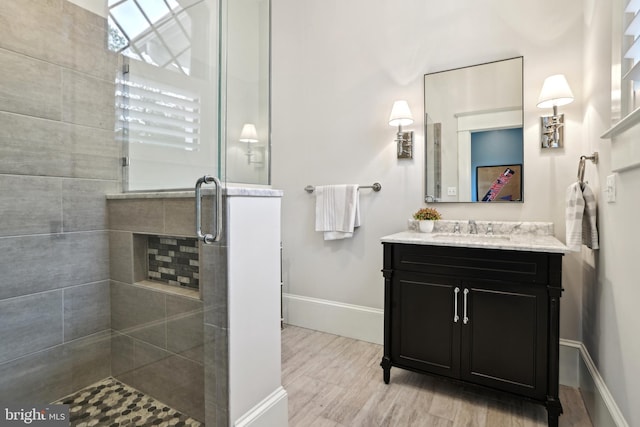 4777 33rd St N, Arlington, VA 22207 - bathroom with baseboards, vanity, wood finished floors, and a stall shower