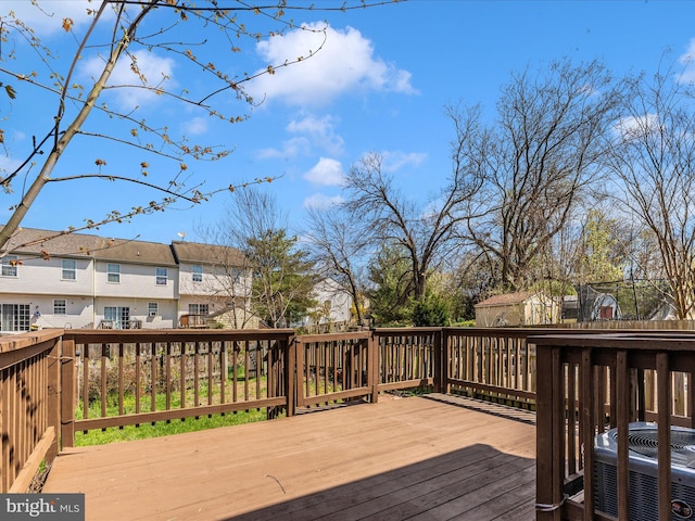 wooden deck featuring a residential view and central AC unit