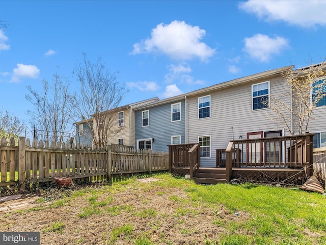 back of house featuring a fenced backyard and a wooden deck