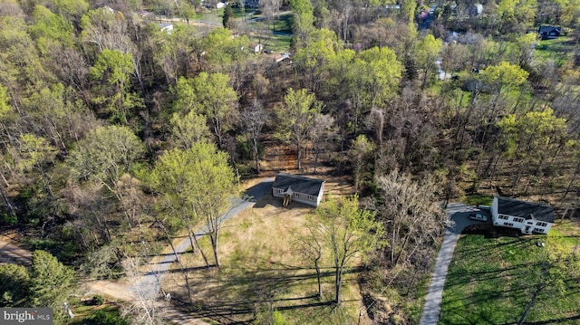 birds eye view of property featuring a view of trees