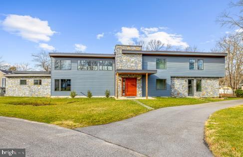 view of front of property with a front lawn and stone siding