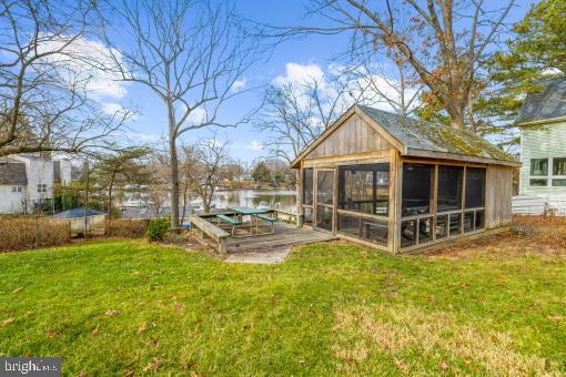 exterior space with a water view and a sunroom