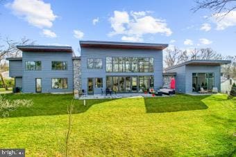 back of house featuring a yard and a patio area