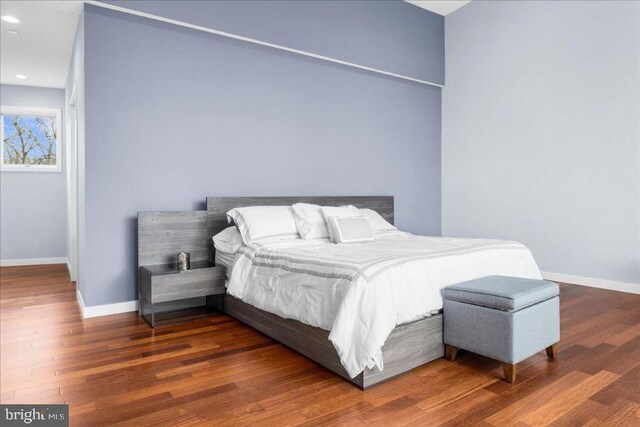 bedroom with baseboards, recessed lighting, and wood finished floors