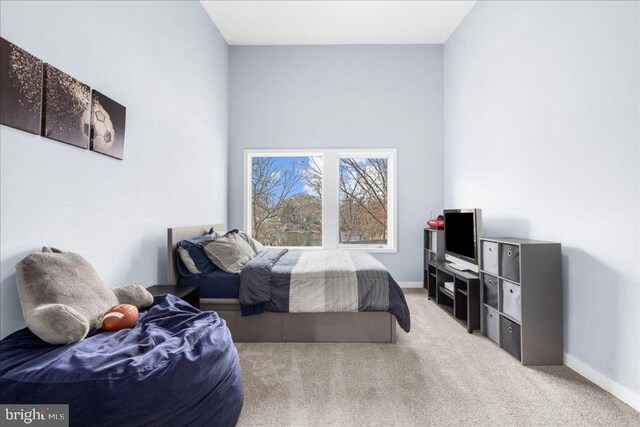 carpeted bedroom featuring baseboards
