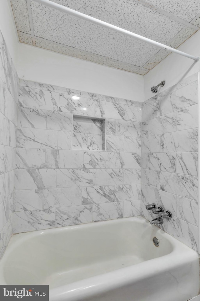 bathroom with washtub / shower combination