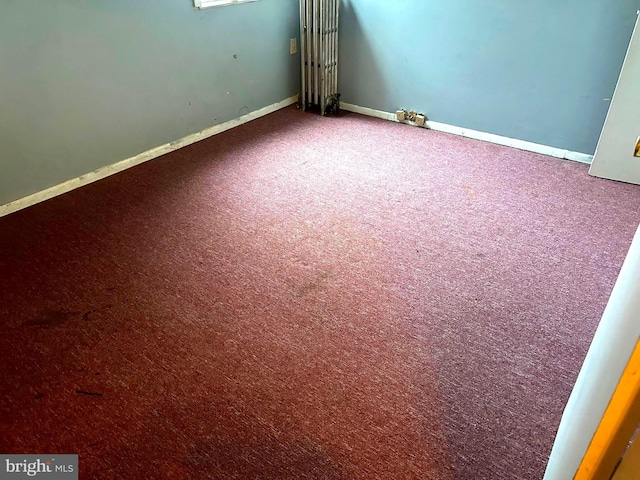 spare room with carpet and baseboards