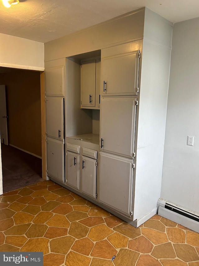 kitchen featuring light countertops and baseboard heating