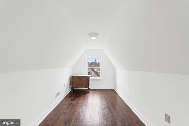 bonus room with baseboards, hardwood / wood-style flooring, visible vents, and vaulted ceiling