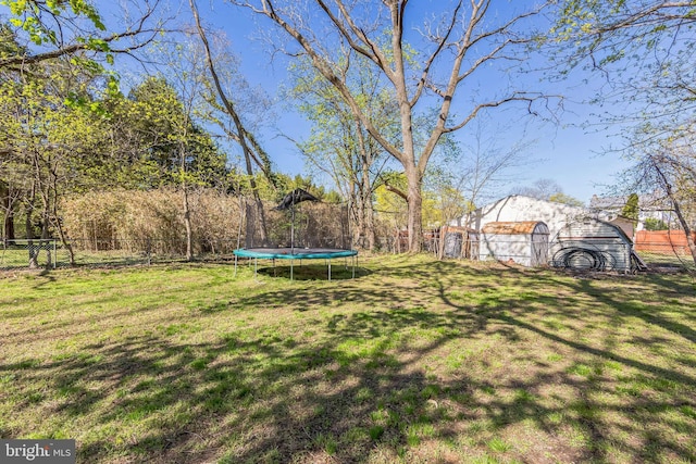 view of yard with a fenced backyard and a trampoline