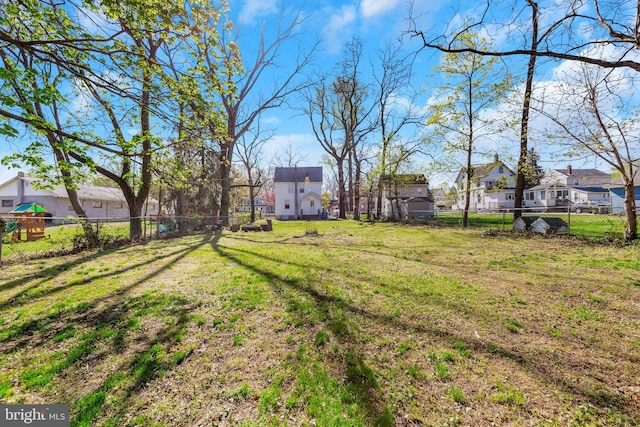 view of yard featuring a fenced backyard and a residential view