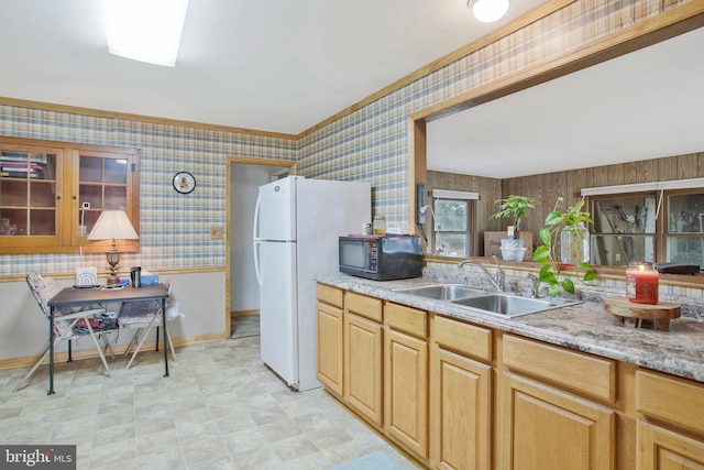 kitchen featuring baseboards, wallpapered walls, ornamental molding, black microwave, and a sink