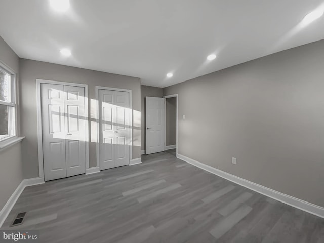 interior space featuring visible vents, baseboards, recessed lighting, and wood finished floors