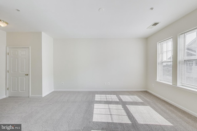 unfurnished room featuring carpet, baseboards, and visible vents