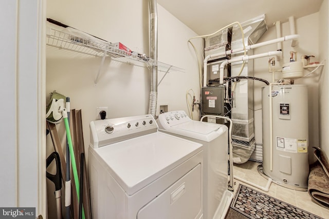 laundry area with separate washer and dryer, laundry area, light tile patterned flooring, and electric water heater