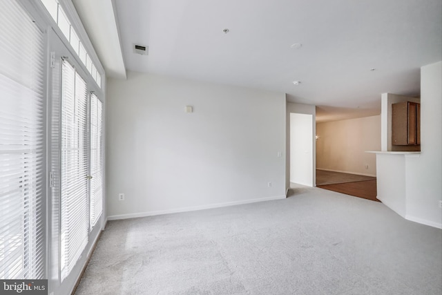 interior space with carpet and baseboards