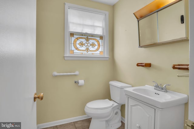 413 W Marble St, Mechanicsburg, PA 17055 - half bathroom with toilet, vanity, baseboards, and tile patterned floors