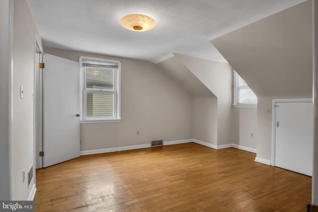 413 W Marble St, Mechanicsburg, PA 17055 - additional living space featuring light wood-type flooring, plenty of natural light, vaulted ceiling, and baseboards
