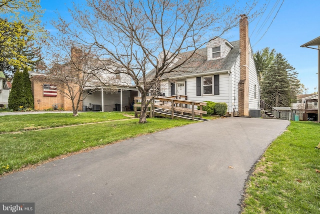 413 W Marble St, Mechanicsburg, PA 17055 - view of front facade with a chimney, a front yard, asphalt driveway, and central AC unit