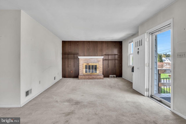 413 W Marble St, Mechanicsburg, PA 17055 - unfurnished living room featuring carpet, wood walls, a brick fireplace, and baseboards