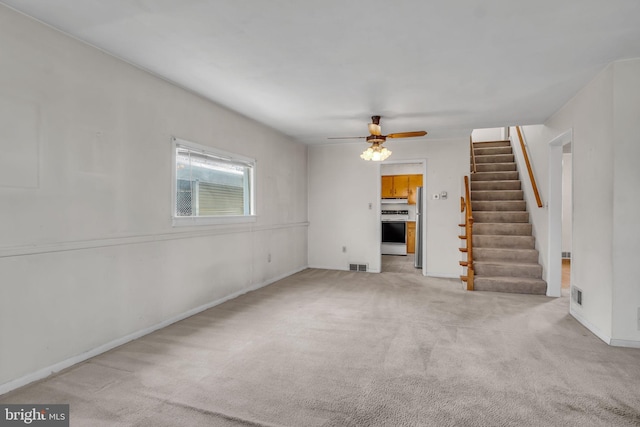 413 W Marble St, Mechanicsburg, PA 17055 - unfurnished living room featuring stairs, a ceiling fan, light colored carpet, and baseboards