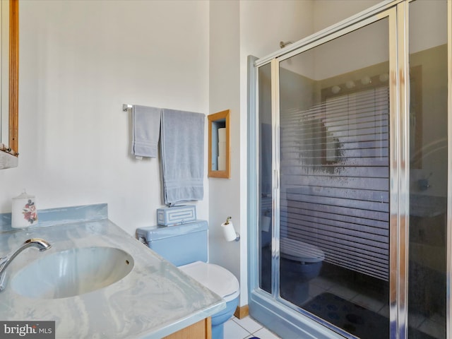 full bath with tile patterned flooring, toilet, a stall shower, and vanity