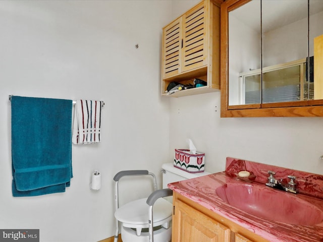 full bath with toilet, a stall shower, and vanity