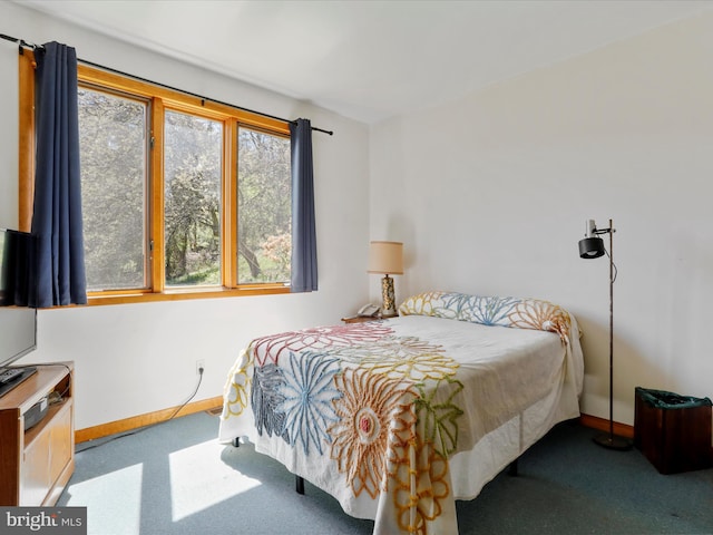 carpeted bedroom featuring baseboards