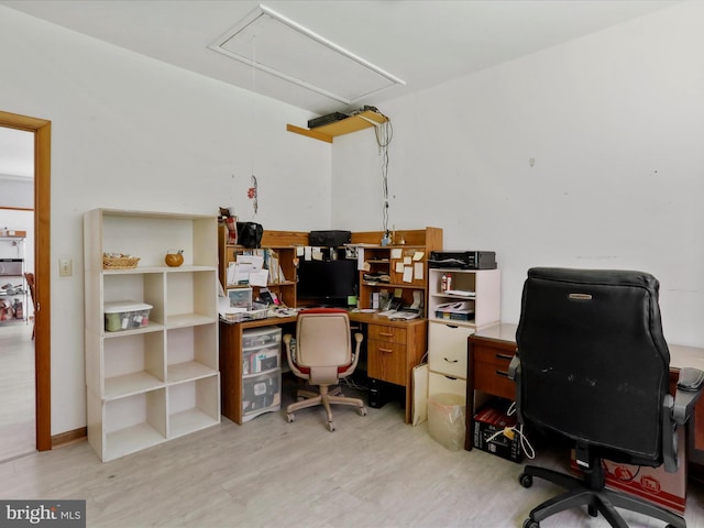 office with light wood finished floors and attic access