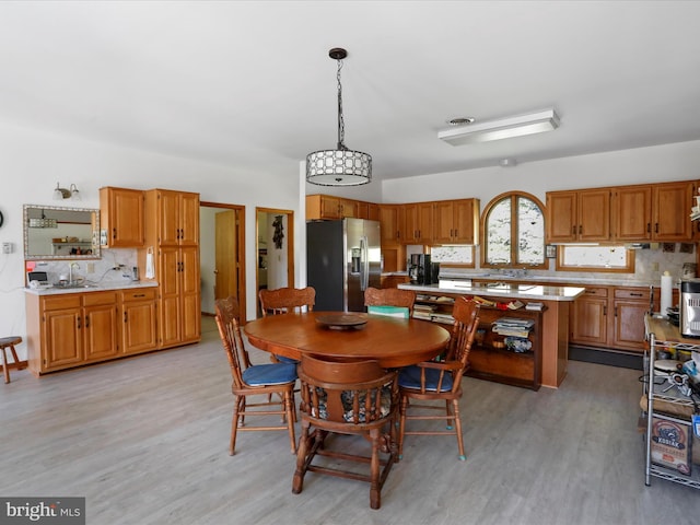 dining space with light wood-type flooring