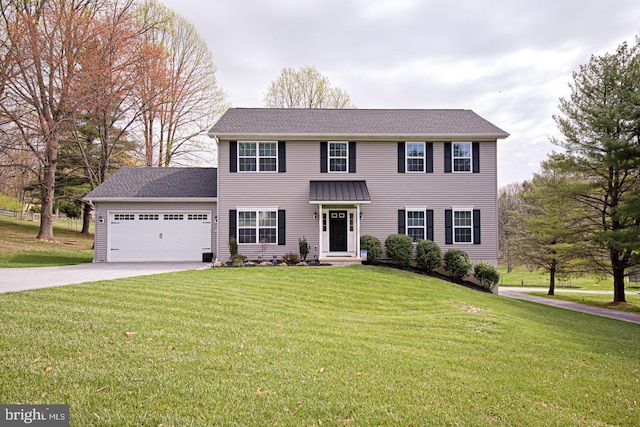 colonial inspired home featuring a garage, a front yard, and concrete driveway