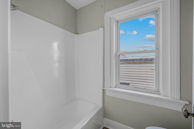 full bathroom featuring baseboards and shower / tub combination