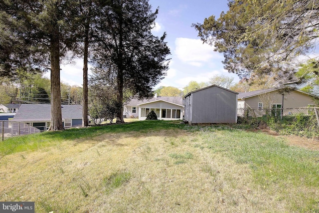 7203 Roanne Dr, Oxon Hill, MD 20745 - view of yard featuring an outdoor structure, fence, and a storage unit